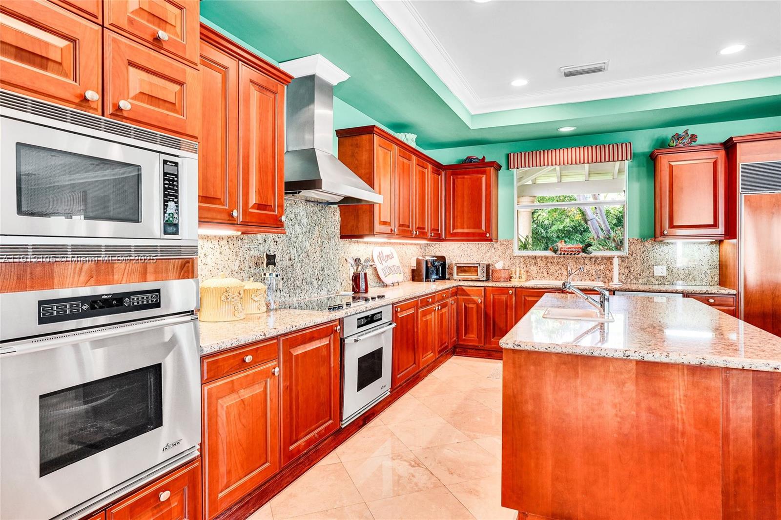 550 Harbor Drive Key Biscayne, FL 33149 - Photo 51 of 65 a kitchen with stainless steel appliances granite countertop a stove a sink and a microwave