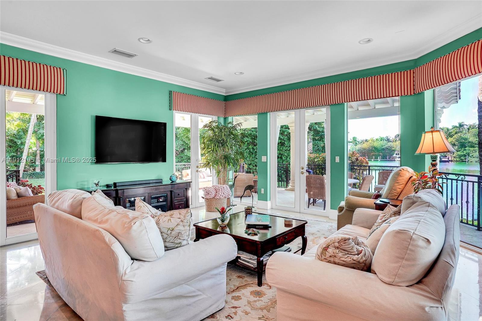 550 Harbor Drive Key Biscayne, FL 33149 - Photo 58 of 65 a living room with furniture a flat screen tv and floor to ceiling windows
