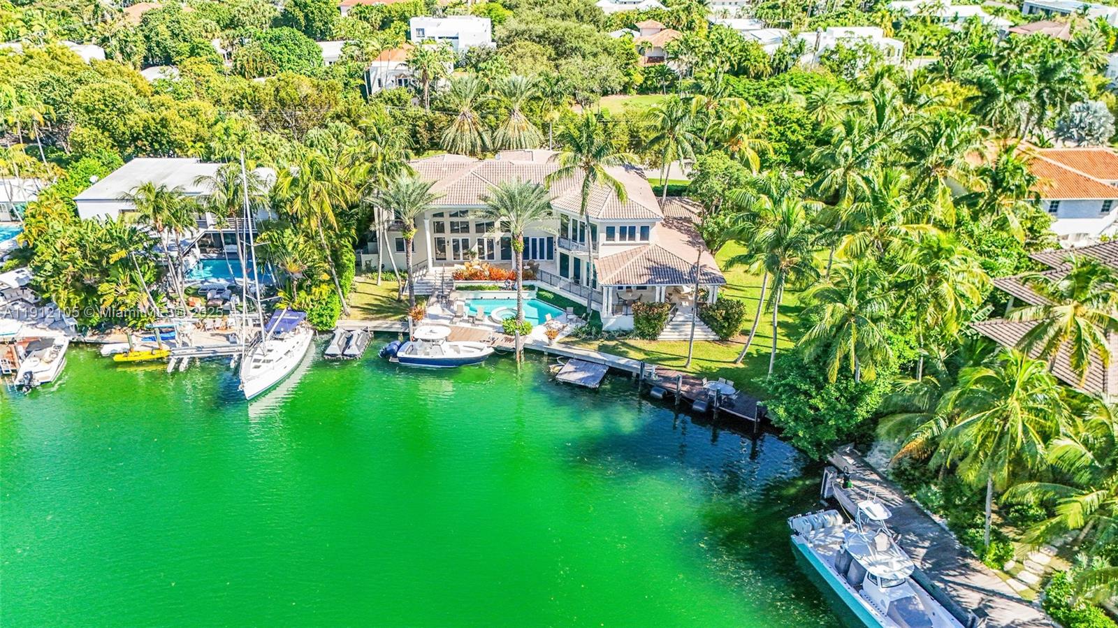 550 Harbor Drive Key Biscayne, FL 33149 - Photo 6 of 65 a aerial view of a house with swimming pool a yard and lake view