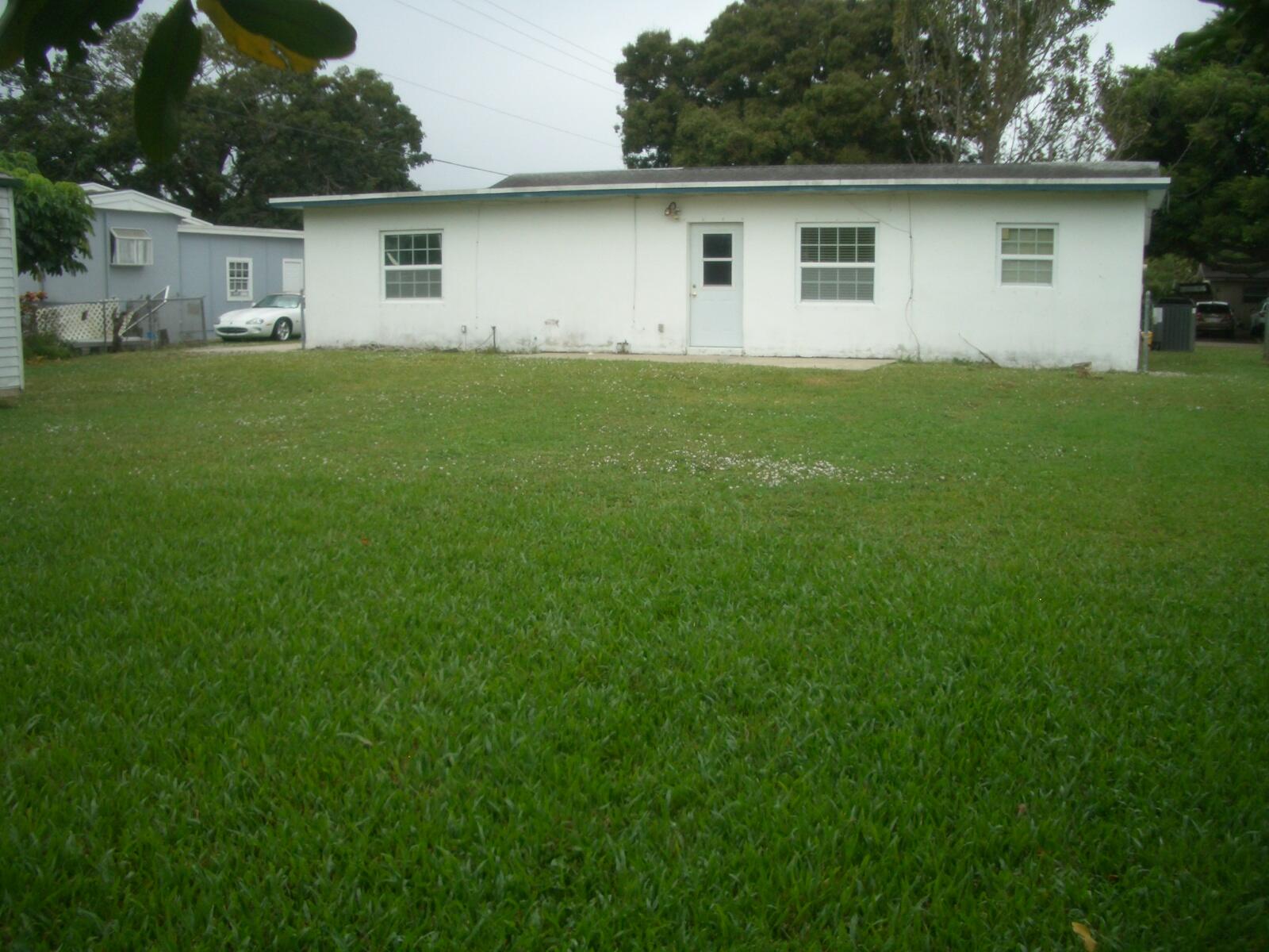 403 Daly Drive Jupiter, FL 33458 - Photo 17 of 27 a house that is sitting in the grass