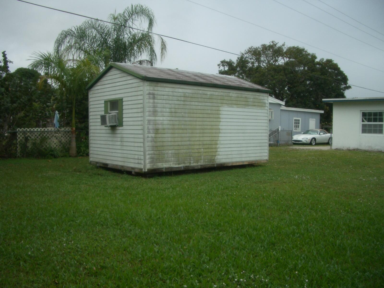 403 Daly Drive Jupiter, FL 33458 - Photo 18 of 27 a front view of a house with a garden