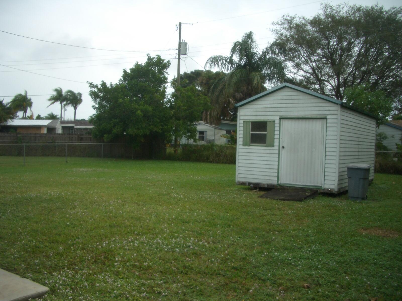 403 Daly Drive Jupiter, FL 33458 - Photo 21 of 27 a view of a house with a yard
