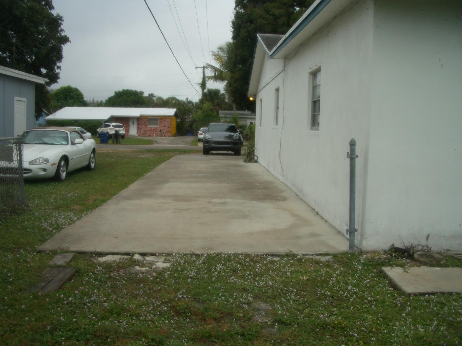 403 Daly Drive Jupiter, FL 33458 - Photo 23 of 27 a view of yard with car parked