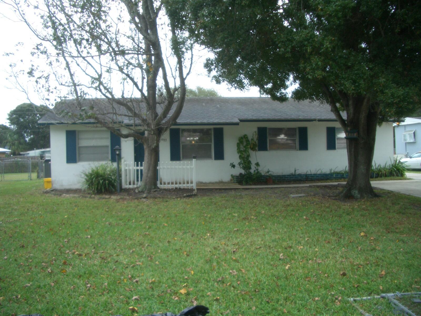 403 Daly Drive Jupiter, FL 33458 - Photo 24 of 27 front view of a house with a tree