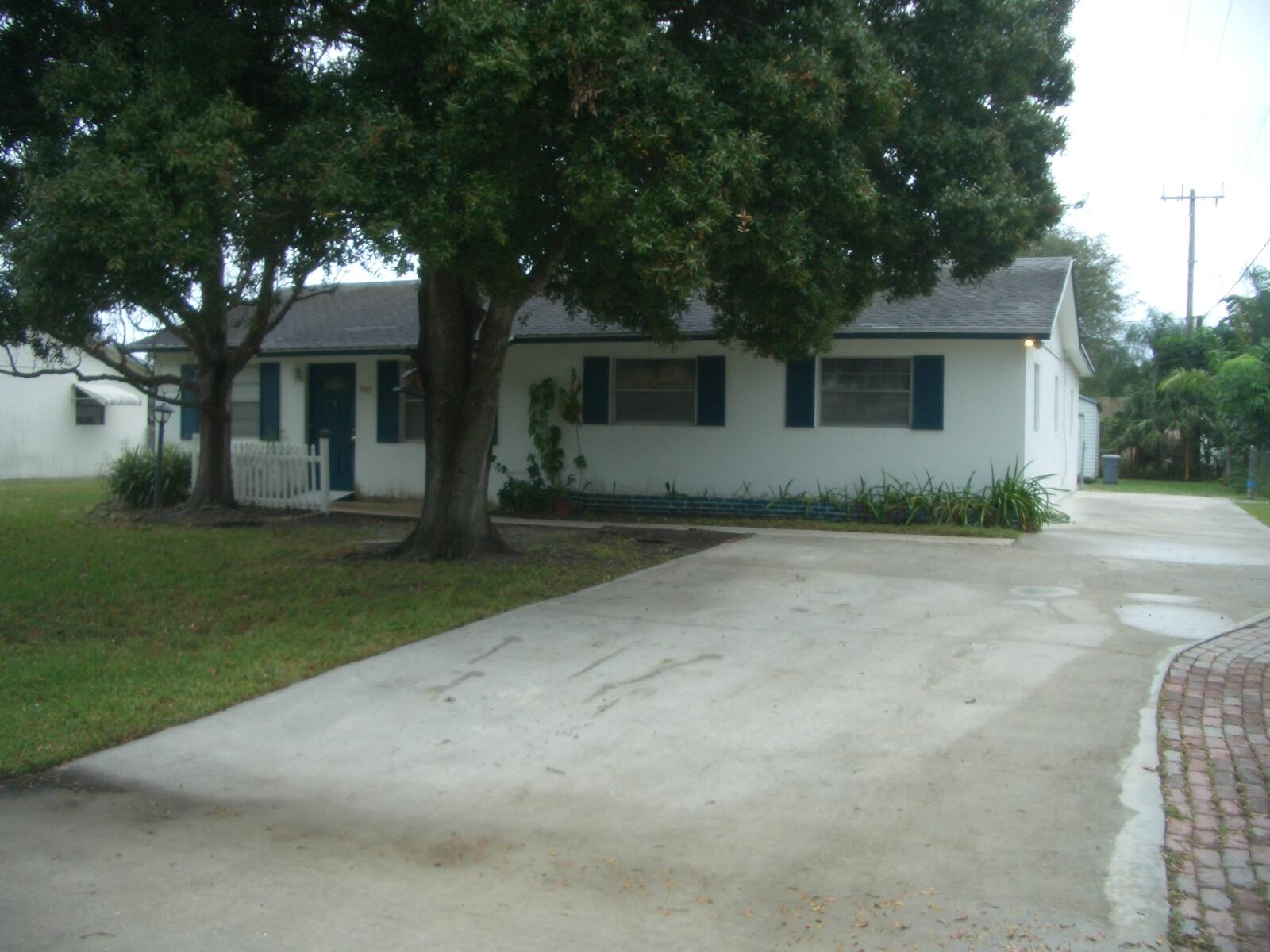 403 Daly Drive Jupiter, FL 33458 - Photo 25 of 27 a front view of a house with garden