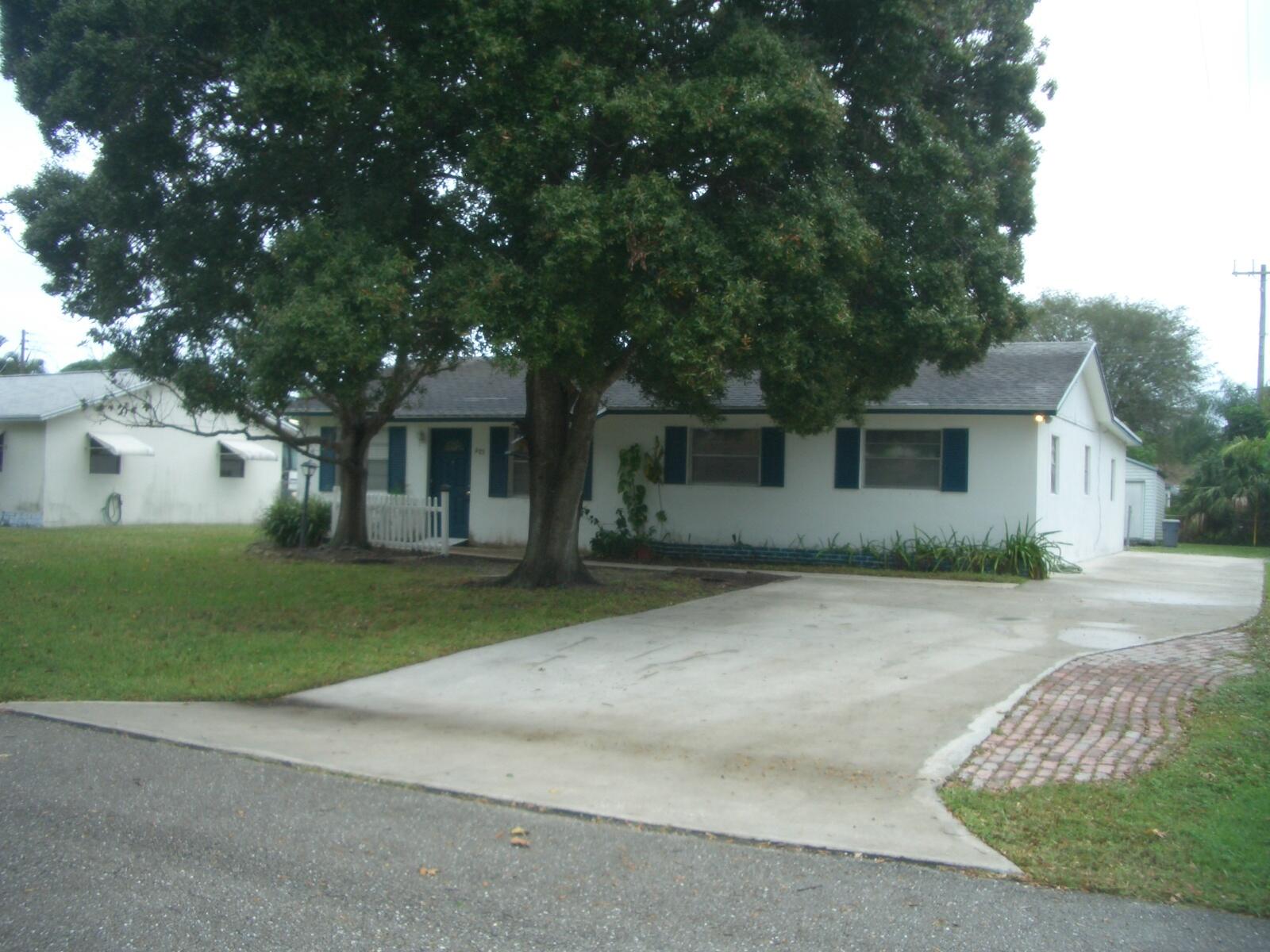 403 Daly Drive Jupiter, FL 33458 - Photo 26 of 27 front view of a house with a yard