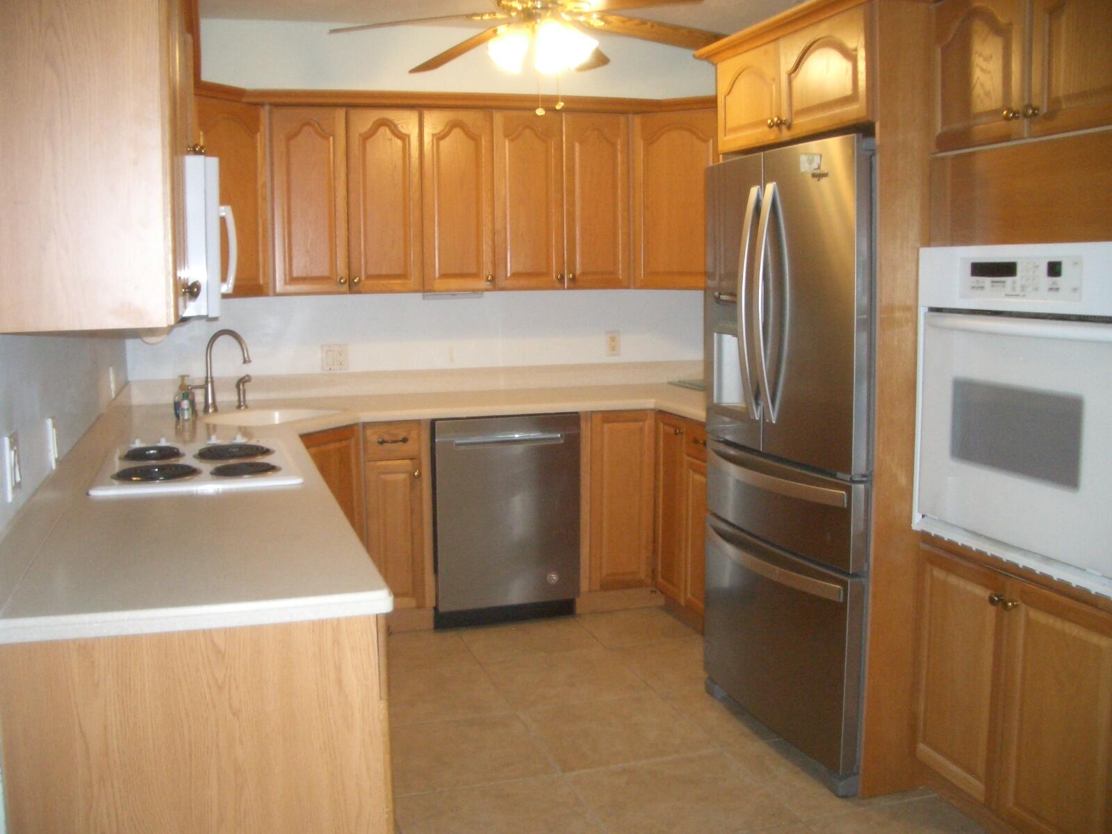 403 Daly Drive Jupiter, FL 33458 - Photo 5 of 27 a kitchen with a refrigerator sink and stove