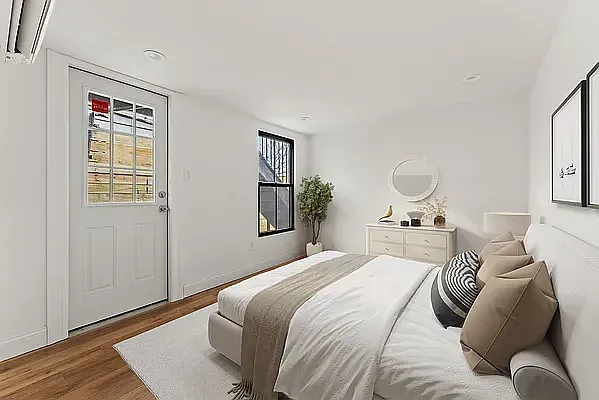 a bedroom with a bed and wooden floor