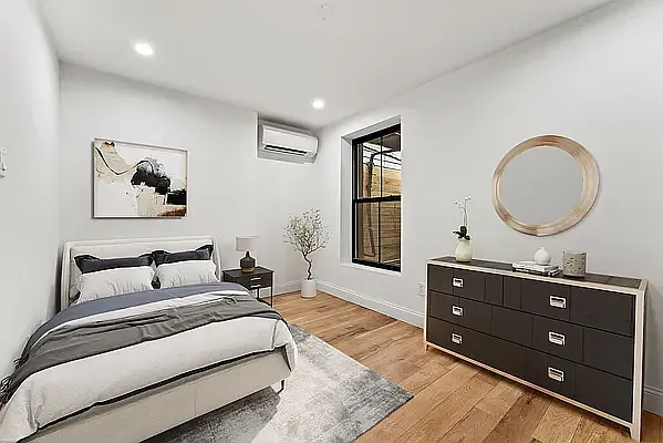 a bedroom with a bed and a dresser