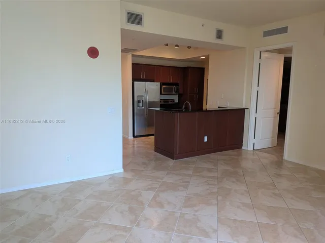 a kitchen with a refrigerator and a microwave
