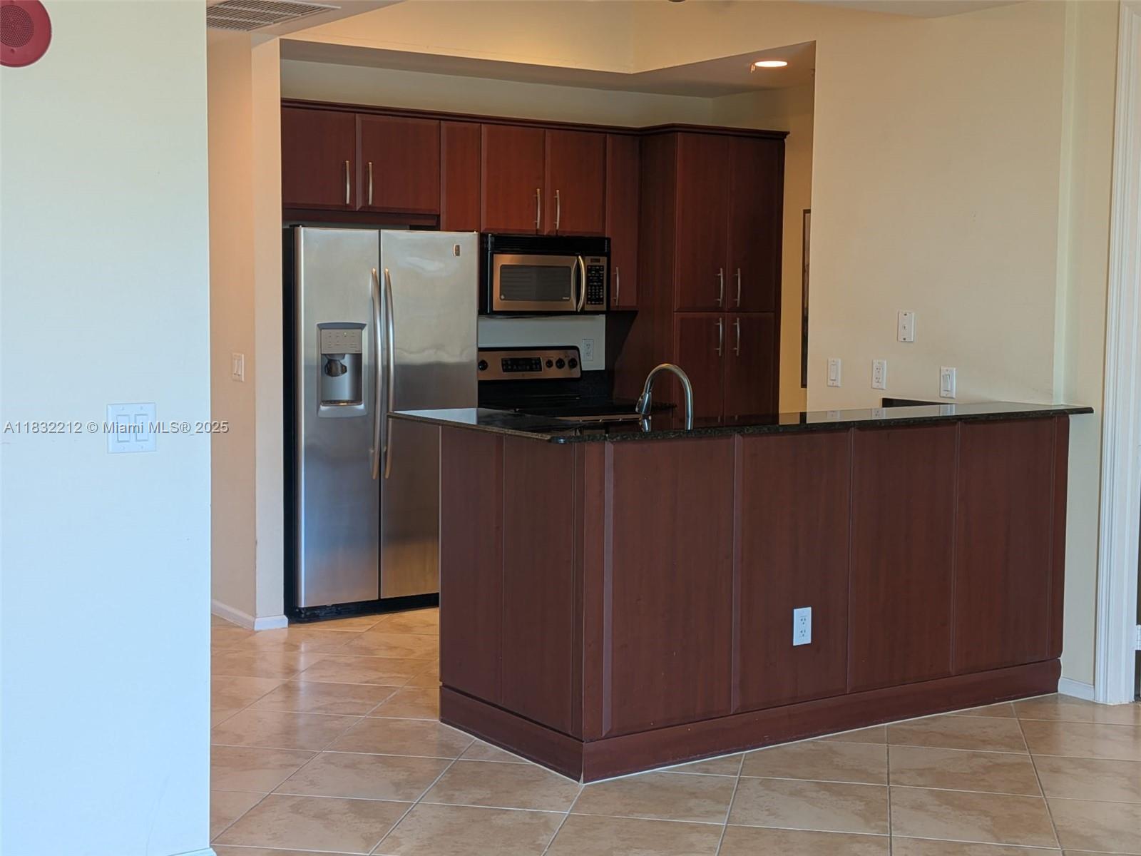 403 South Sapodilla Avenue, Unit 803 West Palm Beach, FL 33401 - Photo 16 of 23 a kitchen with a refrigerator and a microwave