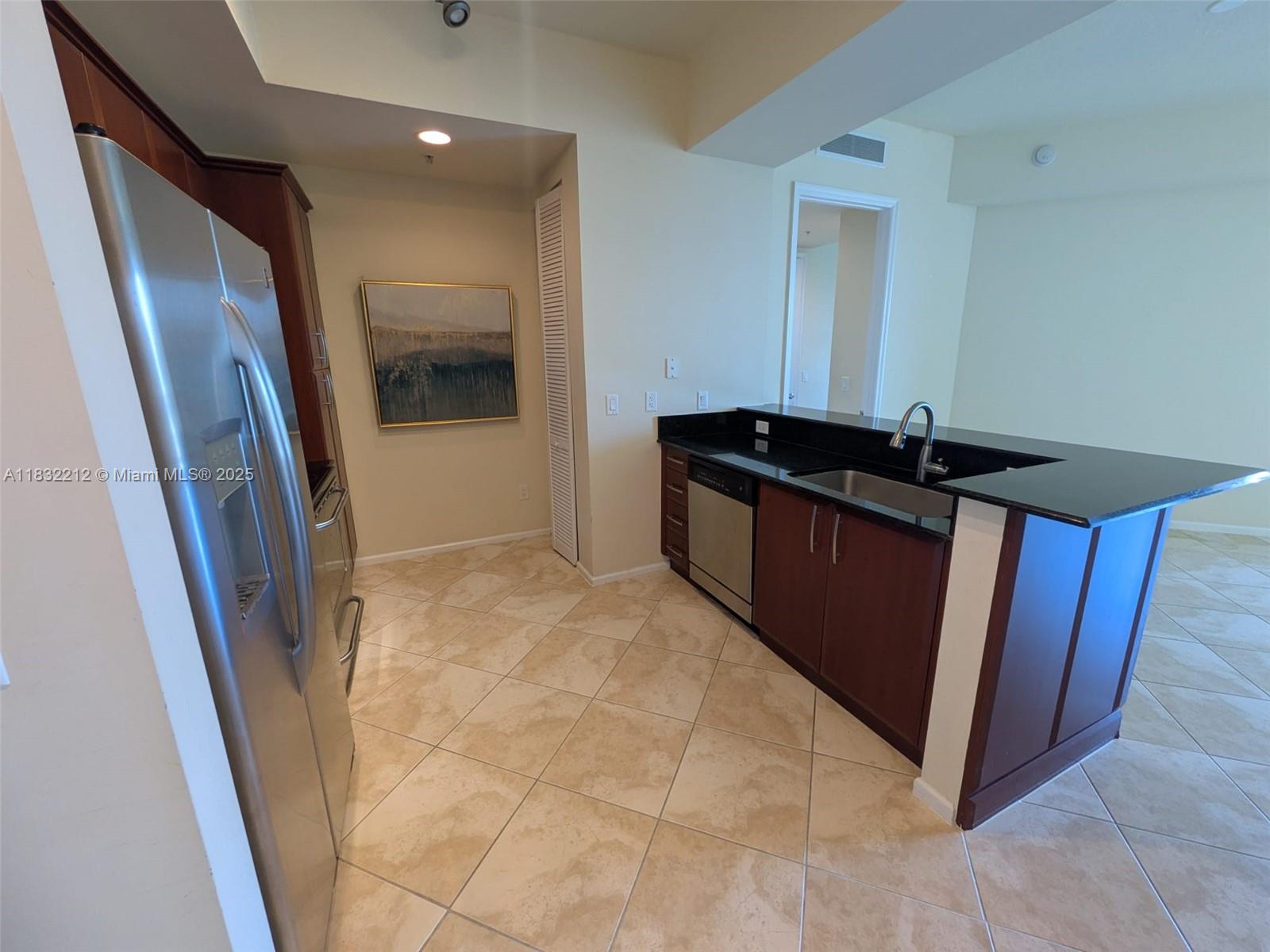 403 South Sapodilla Avenue, Unit 803 West Palm Beach, FL 33401 - Photo 17 of 23 a kitchen with granite countertop a refrigerator and a sink