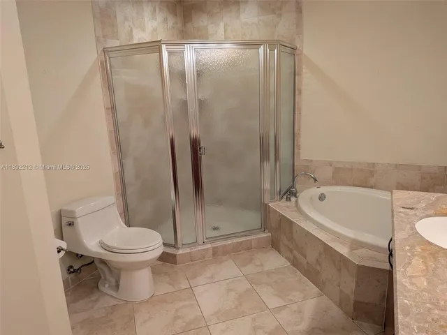 a bathroom with a tub a sink and mirror
