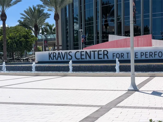 a view of a building with a window and palm trees