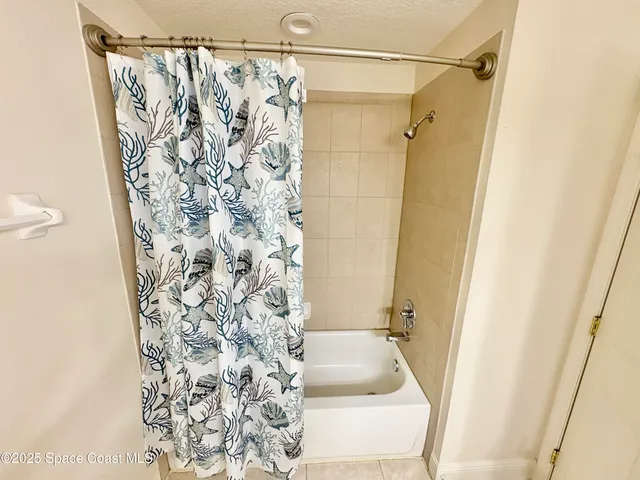 a bathroom with a shower curtain and a sink