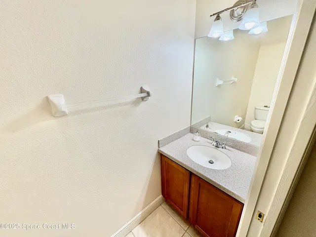 a bathroom with a sink a mirror and vanity