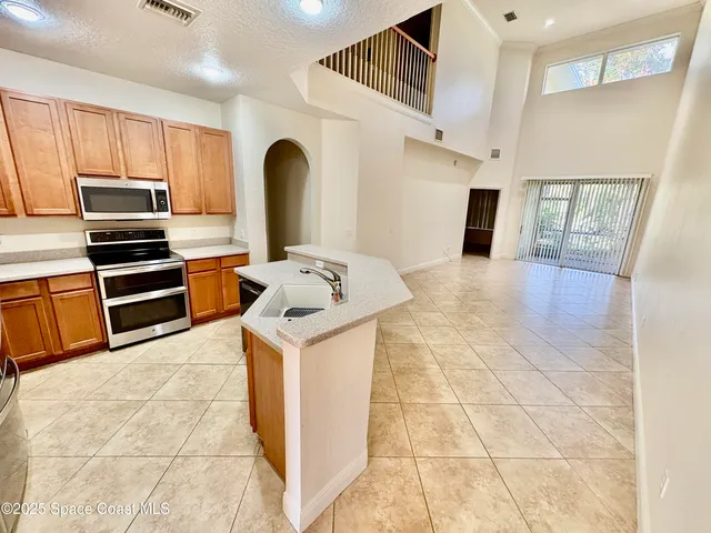 a kitchen with stainless steel appliances a stove a sink cabinets and a counter top space