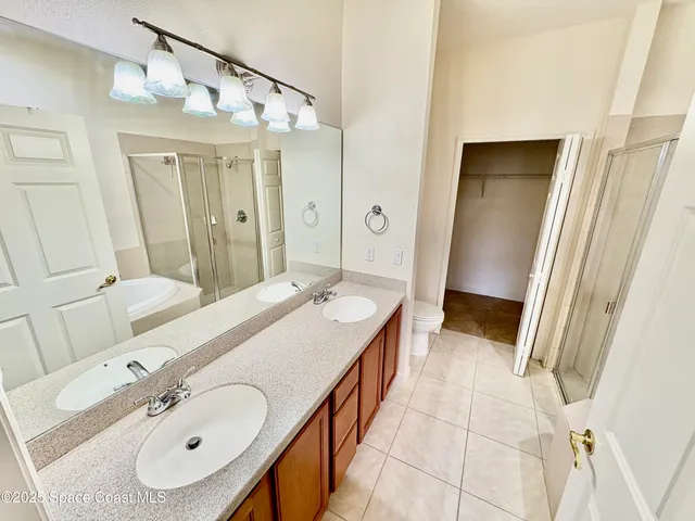 a spacious bathroom with a tub sink and mirror