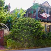 a front view of a house with a garden