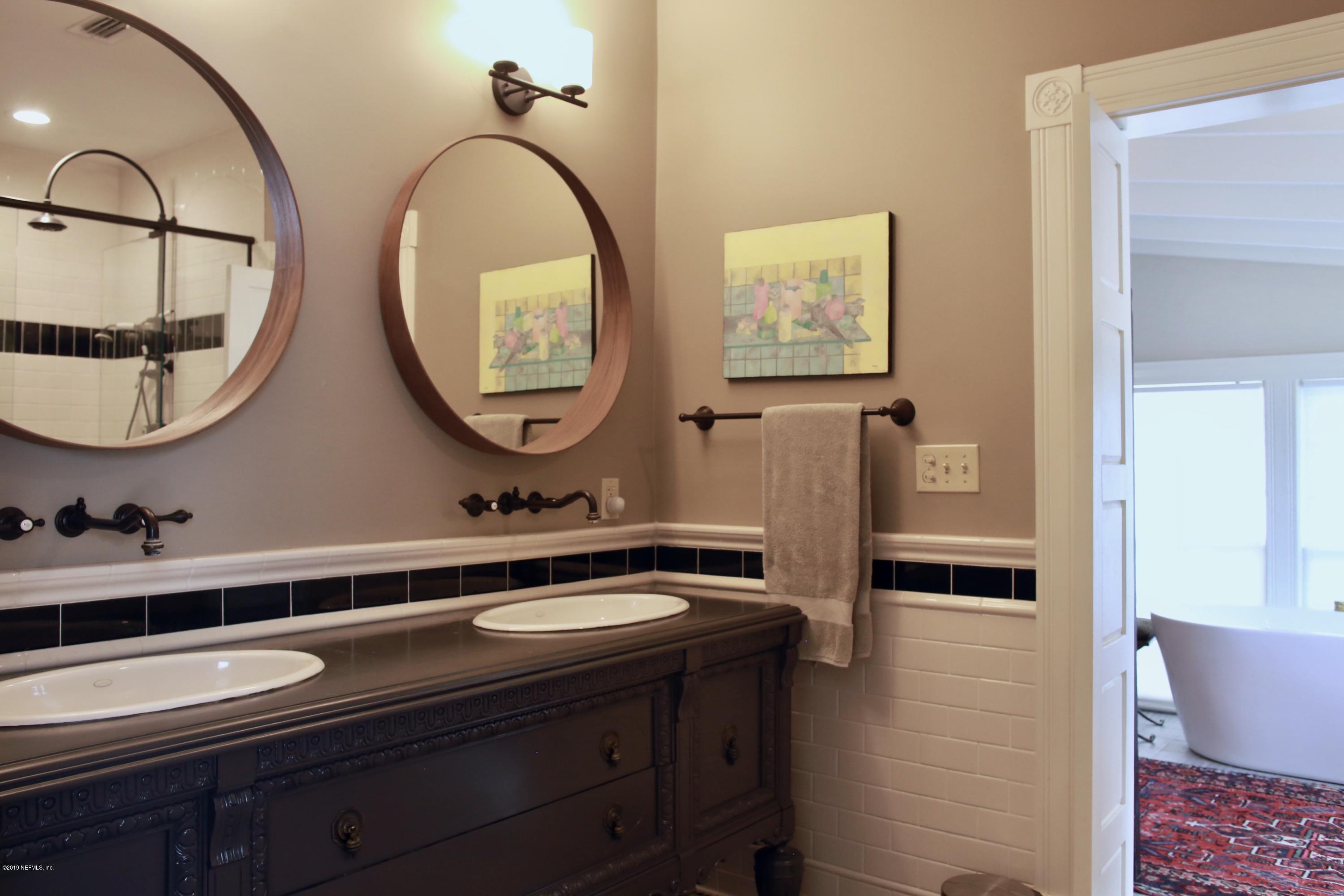 15 Bridge Street St. Augustine, FL 32084 - Photo 15 of 37 a bathroom with a double vanity sink and a mirror