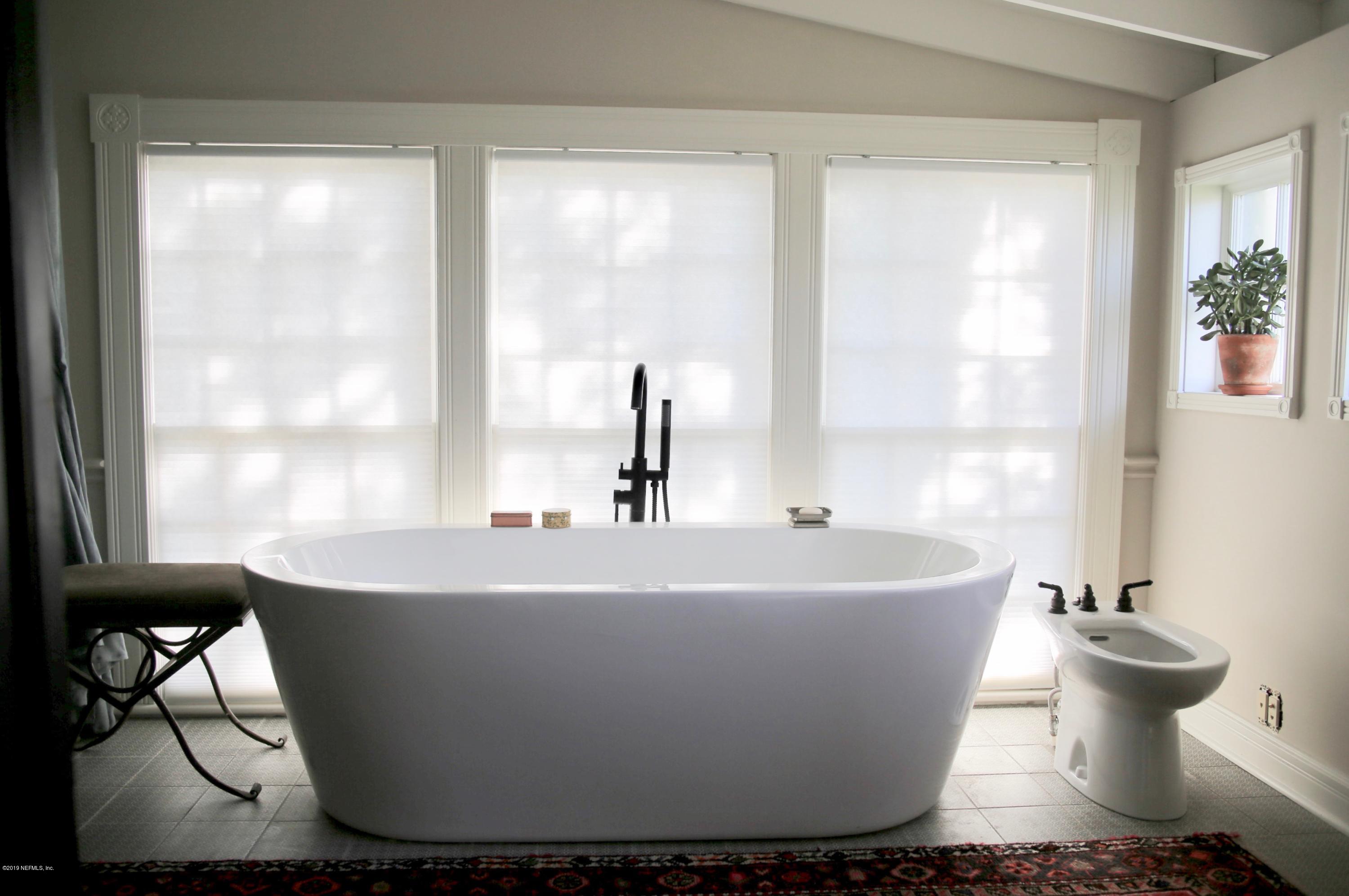 15 Bridge Street St. Augustine, FL 32084 - Photo 16 of 37 a white bath tub sitting in a bathroom next to a window