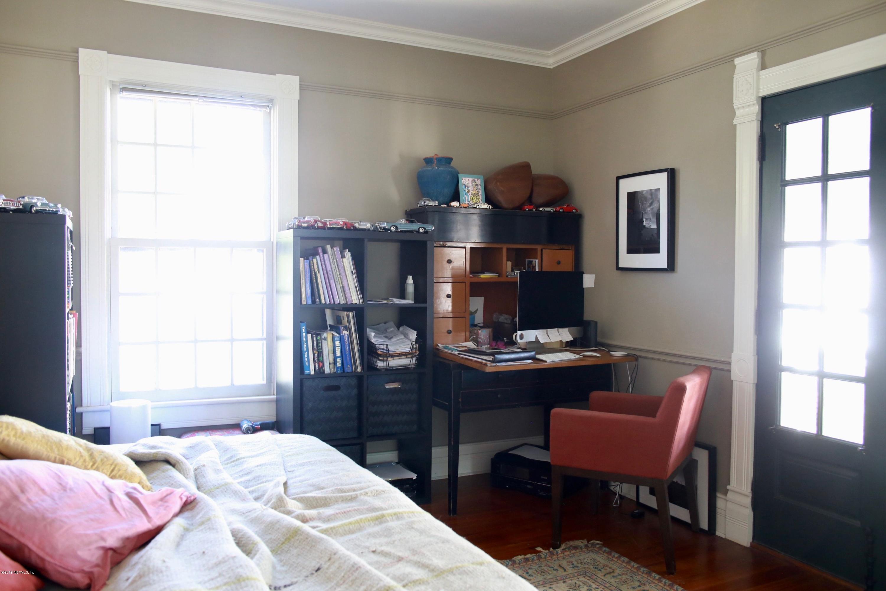 15 Bridge Street St. Augustine, FL 32084 - Photo 23 of 37 a bedroom with a bed and a desk in it