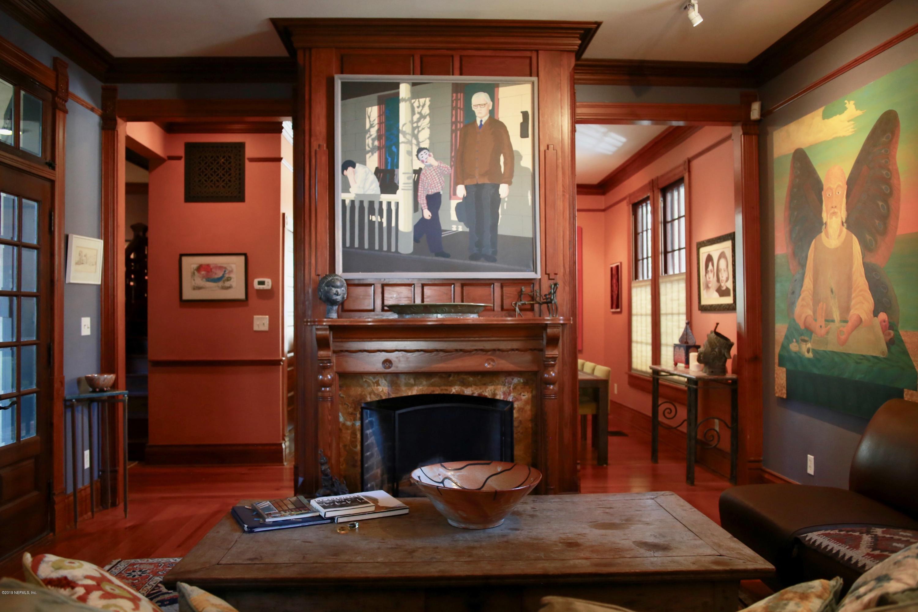 15 Bridge Street St. Augustine, FL 32084 - Photo 6 of 37 a living room with furniture a fireplace and a floor to ceiling window