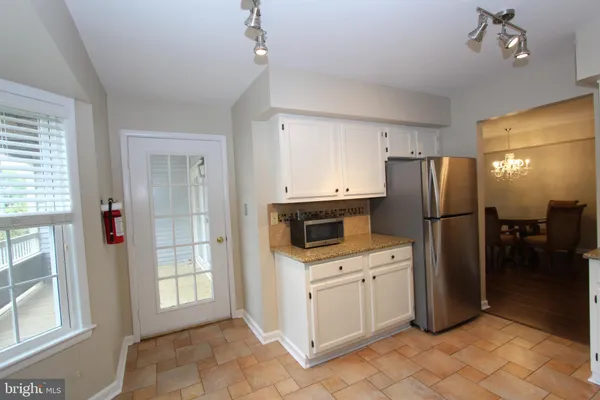 a kitchen with a refrigerator sink and cabinets