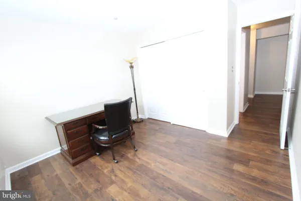 a bathroom with a granite countertop sink a toilet a mirror and bathtub