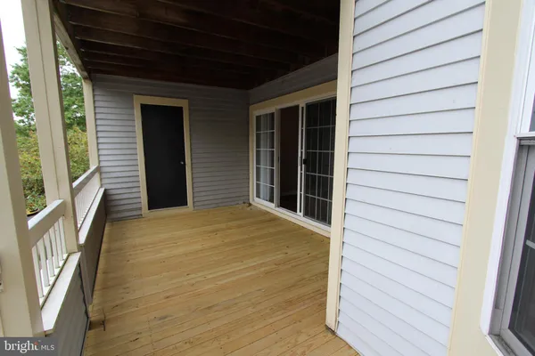 a view of a house with a door and wooden walls