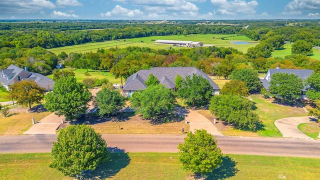 a view of a lake with a big yard and potted plants