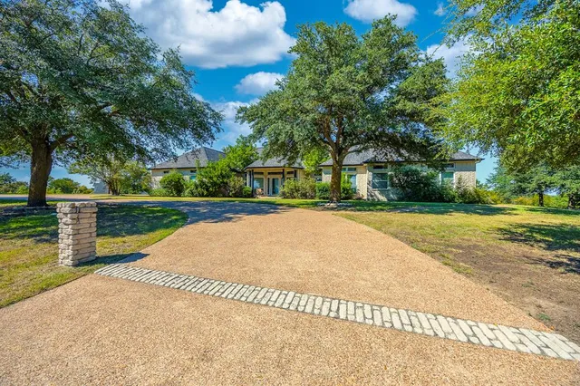 a view of park with large trees