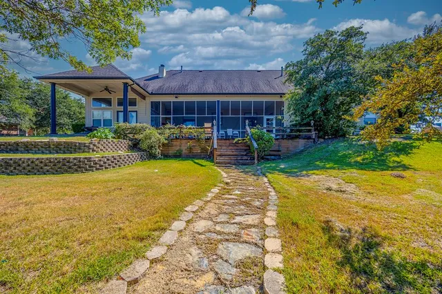 a view of a house with backyard and sitting area