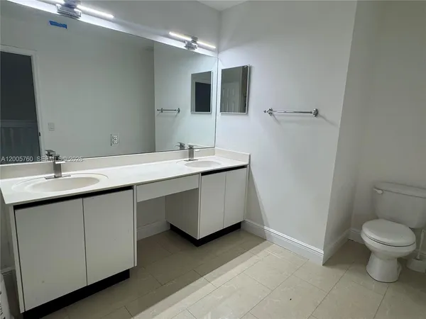 a bathroom with a double vanity sink and a mirror