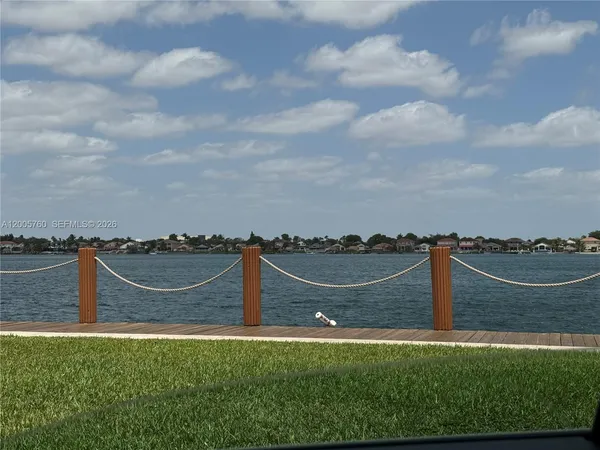 a view of lake with houses in the back