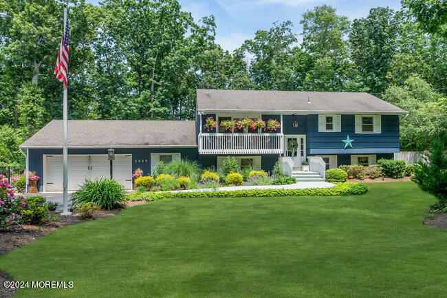 3235 Ridgewood Road Allenwood, NJ 08720 - Photo 1 of 53 a front view of a house with a yard table and chairs