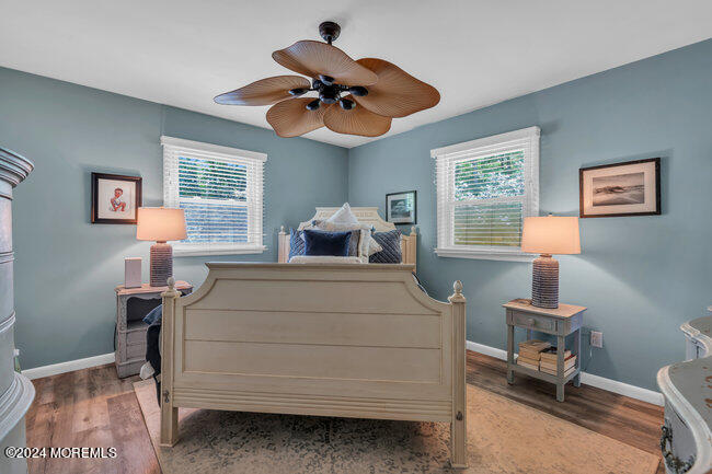3235 Ridgewood Road Allenwood, NJ 08720 - Photo 13 of 53 a bedroom with a bed and a chandelier