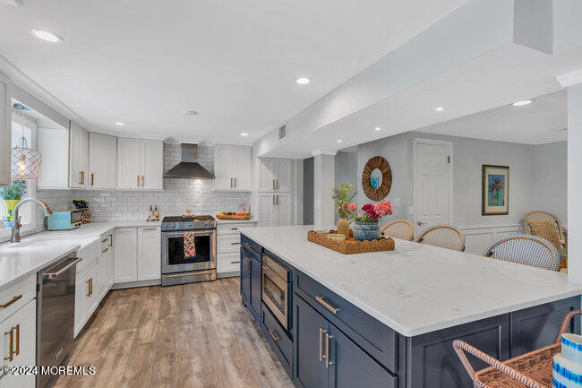 3235 Ridgewood Road Allenwood, NJ 08720 - Photo 25 of 53 a kitchen with kitchen island white cabinets and stainless steel appliances