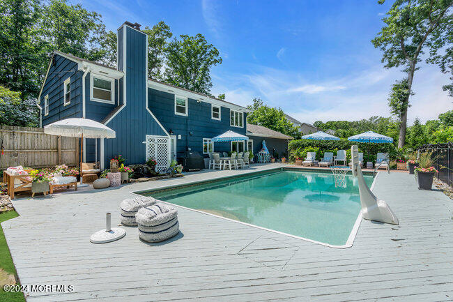 3235 Ridgewood Road Allenwood, NJ 08720 - Photo 34 of 53 a view of a house with swimming pool and sitting area