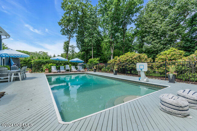 3235 Ridgewood Road Allenwood, NJ 08720 - Photo 36 of 53 a view of a swimming pool with a patio and plants