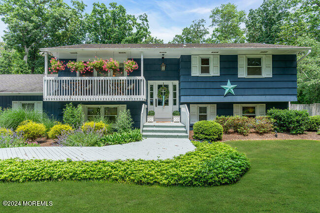 3235 Ridgewood Road Allenwood, NJ 08720 - Photo 4 of 53 a front view of a house with a yard and potted plants