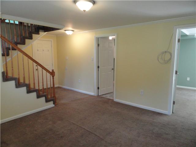 1050 Steel Springs Road Clarksville, TN 37040 - Photo 17 of 20 Another view of downstairs den/living area showing access from stairs and entry to additional downstairs finished rooms, bathroom and garage. What great possibilities for this space!