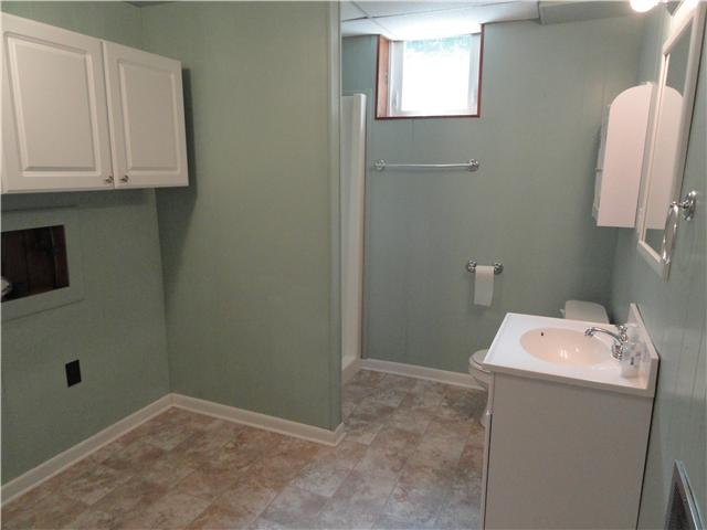 1050 Steel Springs Road Clarksville, TN 37040 - Photo 20 of 20 Large bathroom downstairs has new flooring, a large utility area with cabinets, and a spacious linen closet. This is bathroom number 3 in this home!