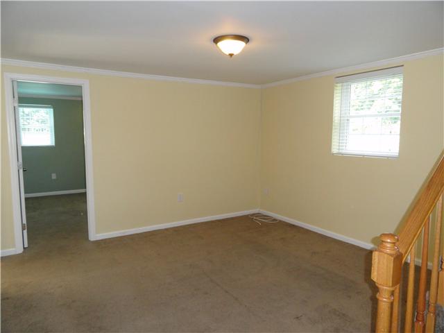 1050 Steel Springs Road Clarksville, TN 37040 - Photo 5 of 20 Wonderful downstairs den/living area has great natural light, with smooth ceilings, wood blinds, fresh paint. This is such a wonderful bonus living area with easy access to 2 additional rooms, a large bathroom/utility area and garage.