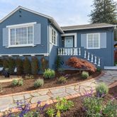 a backyard of a house with yard and outdoor seating