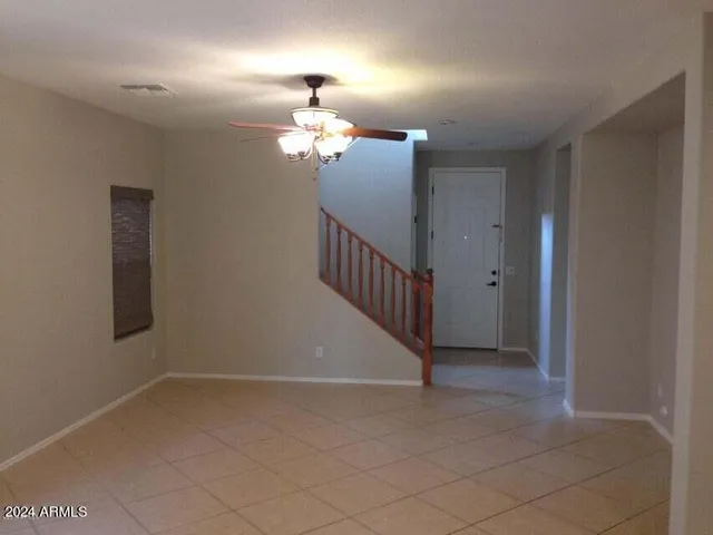a view of a livingroom with a ceiling fan and window