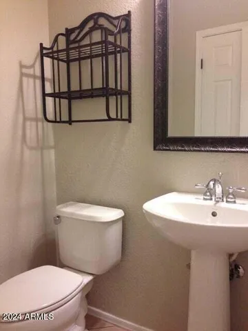 a bathroom with a sink a mirror and a toilet