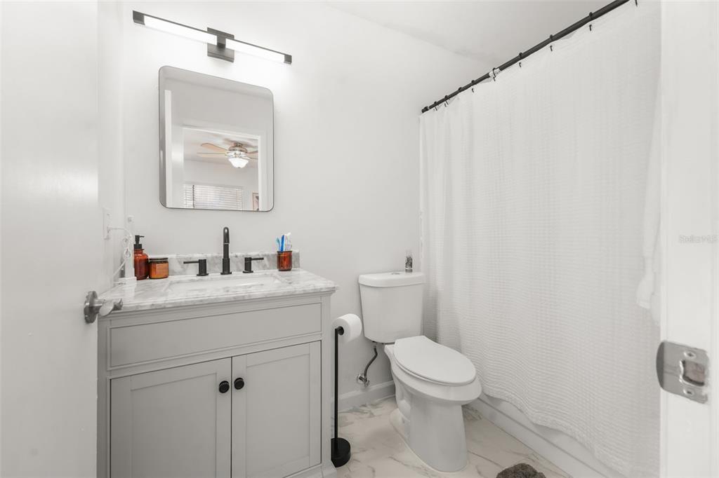2735 Southwest 35th Place, Unit 903 Gainesville, FL 32608 - Photo 11 of 21 a bathroom with a toilet a sink and mirror