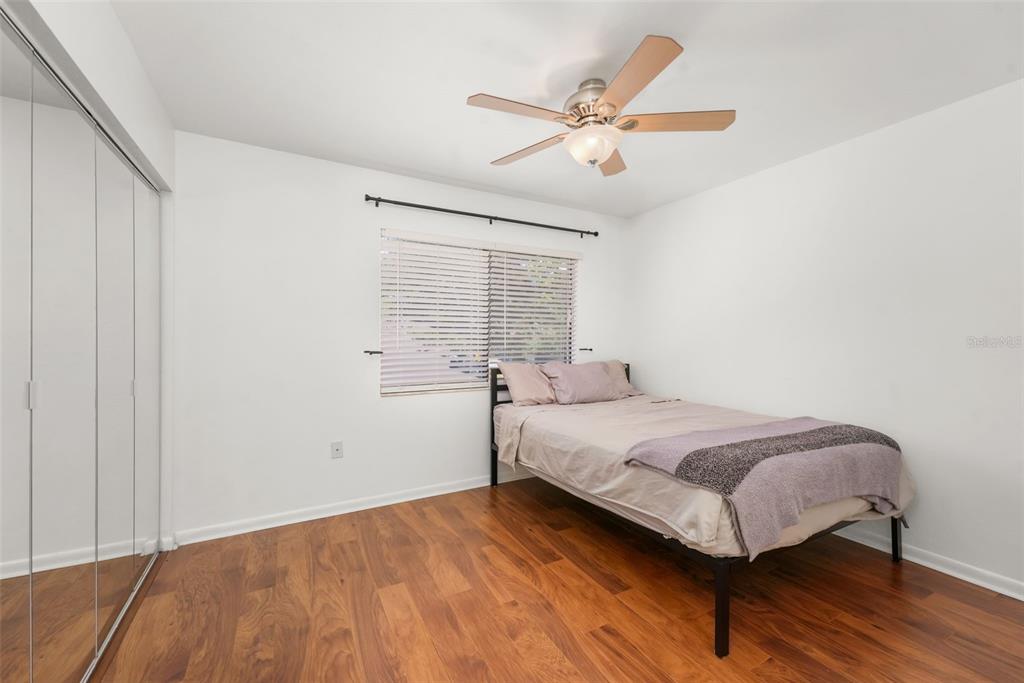 2735 Southwest 35th Place, Unit 903 Gainesville, FL 32608 - Photo 12 of 21 a bedroom with a bed and a chandelier