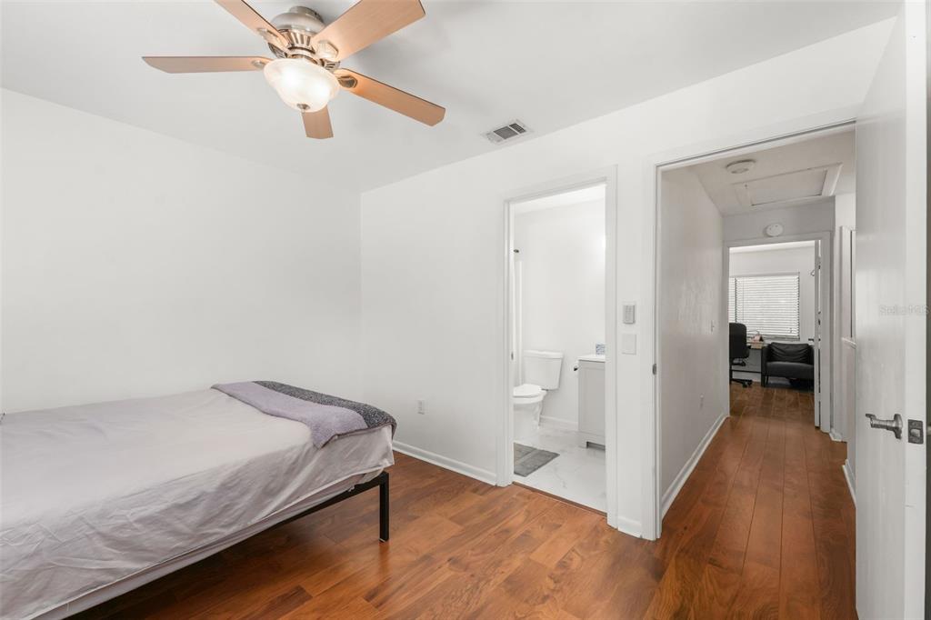 2735 Southwest 35th Place, Unit 903 Gainesville, FL 32608 - Photo 13 of 21 a view of a bedroom with wooden floor